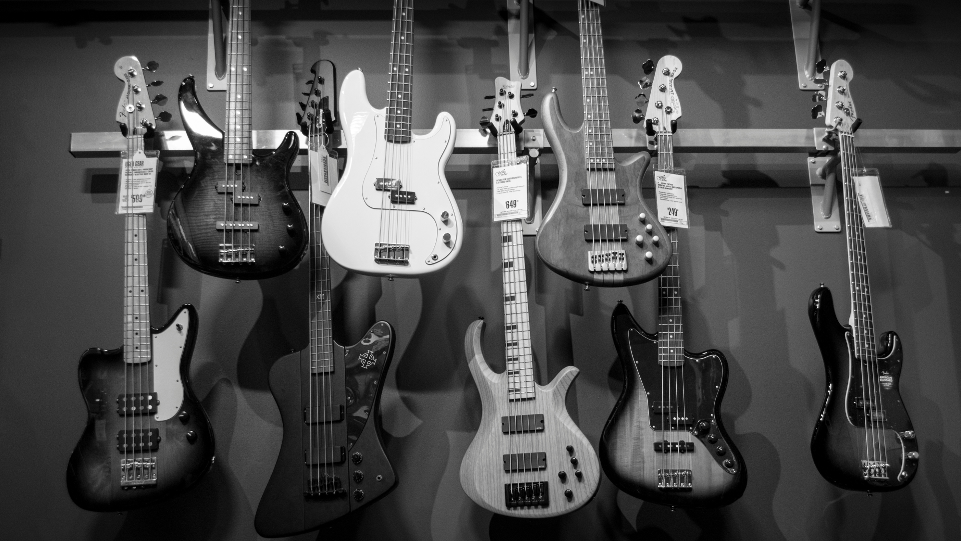 Bass guitar hanging in an instrument shop. Black and White photo