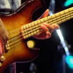 Bass player playing notes higher up the fretboard