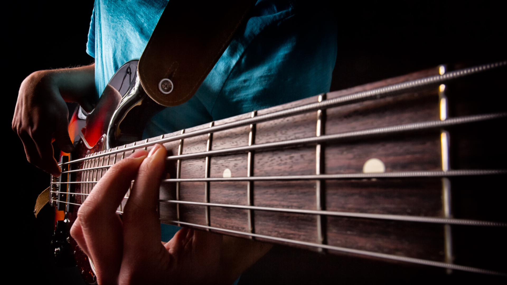 Bass player playing a chord