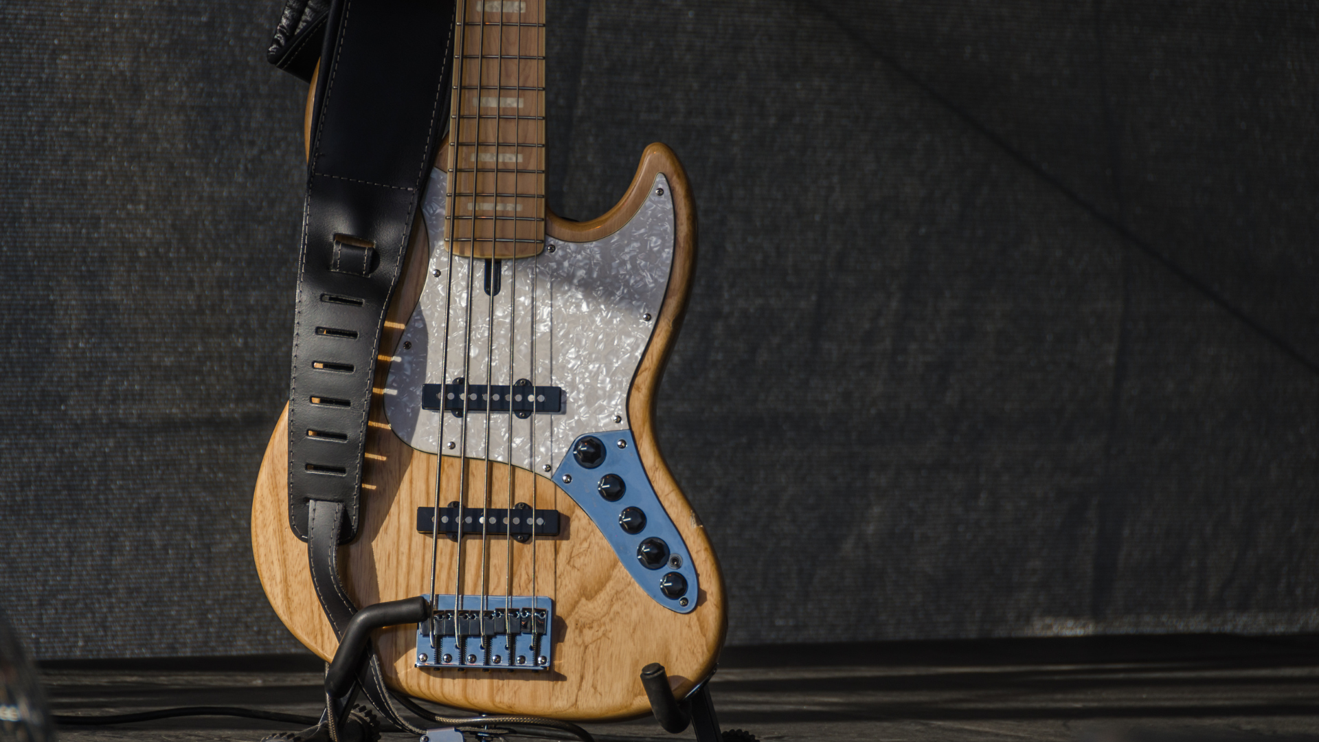 A bass guitar learning against a wall