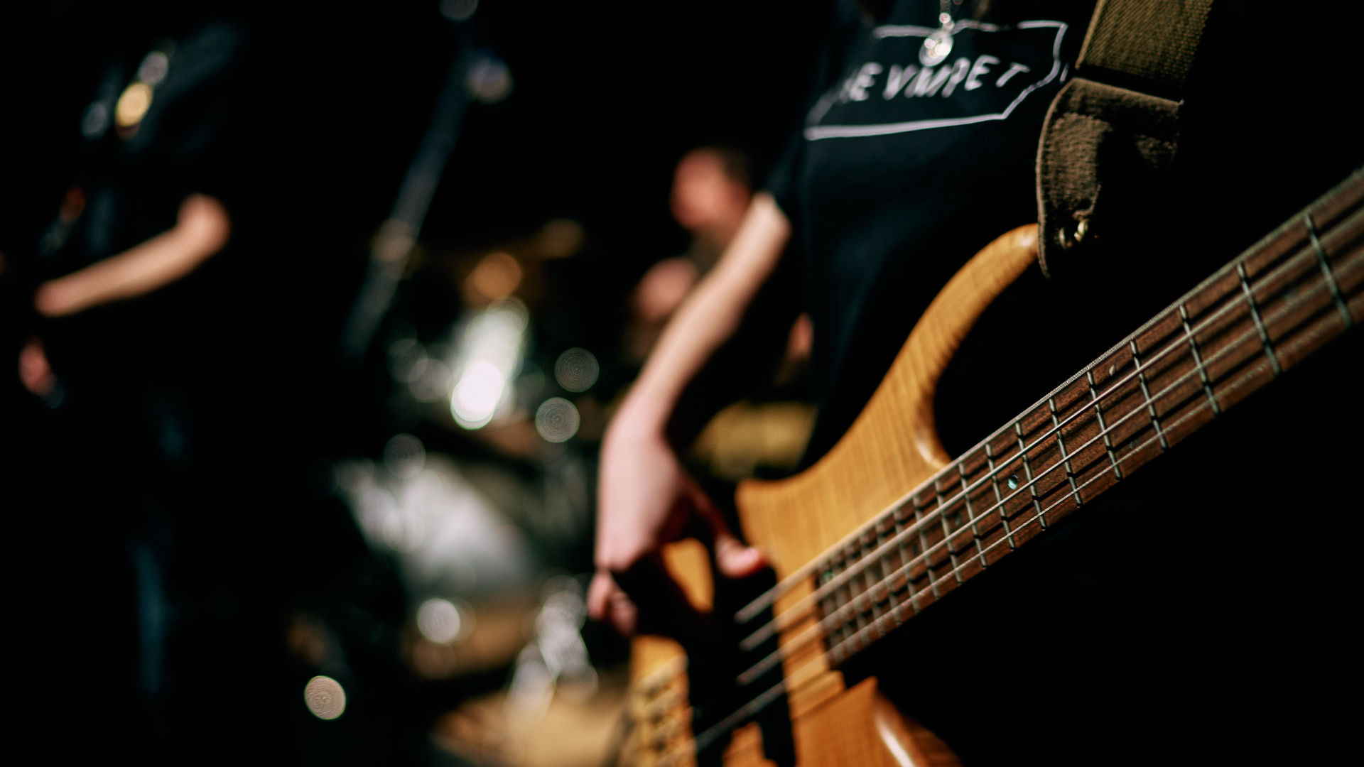 A bass player with a funk band on stage