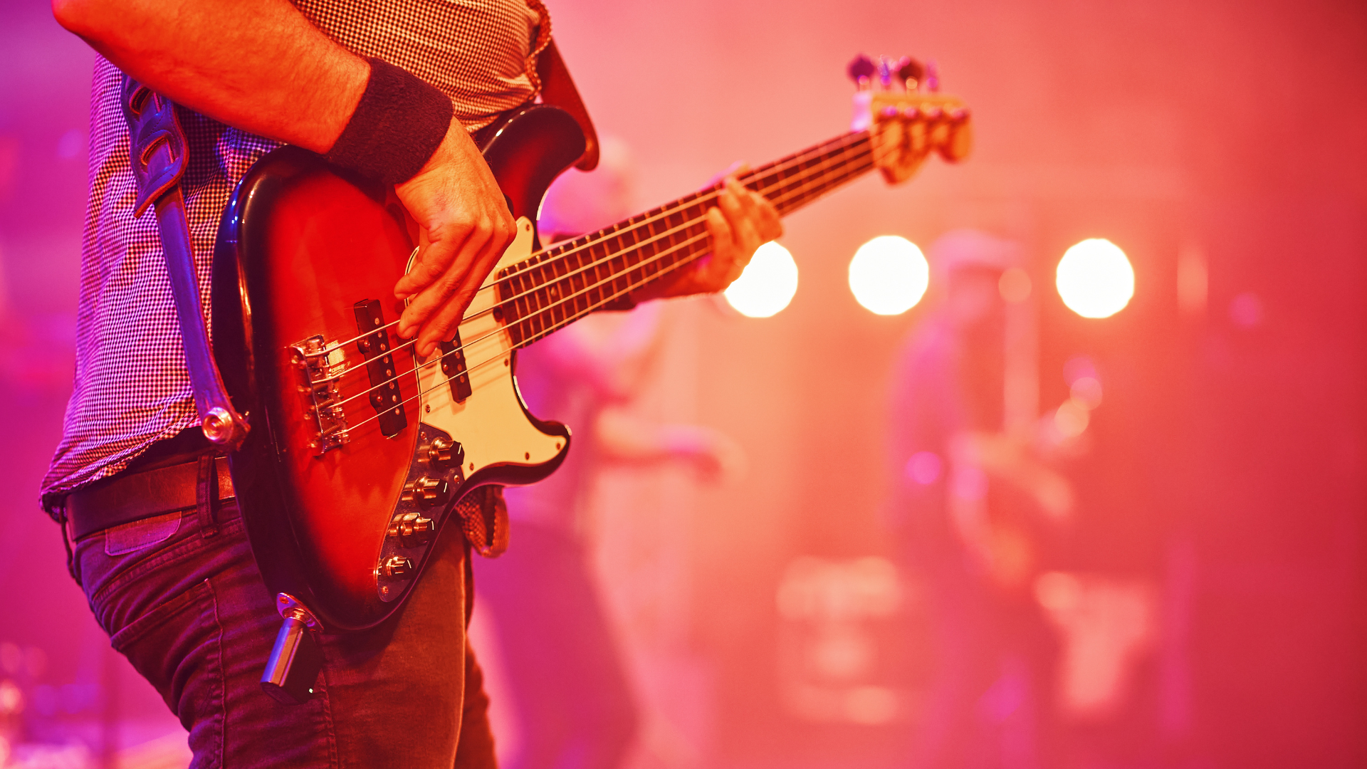 Bass player with a Fender style instrument on stage