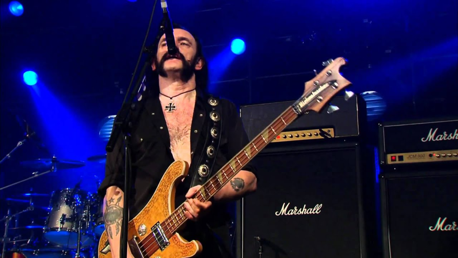 Lemmy playing bass guitar on stage with Motorhead