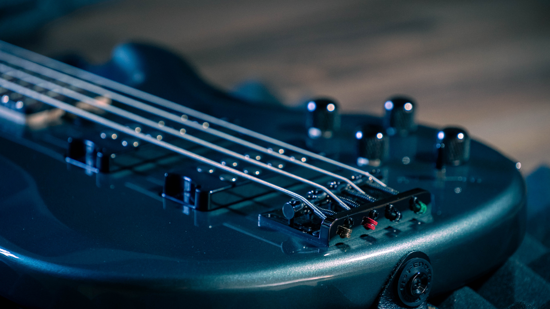 Metal bass guitar laying on the floor